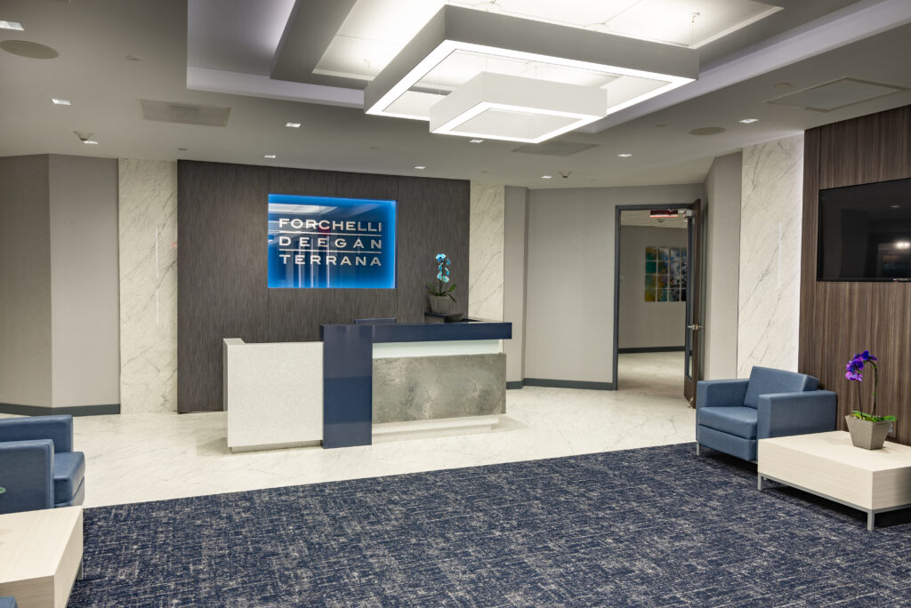 Modern office lobby with reception desk.